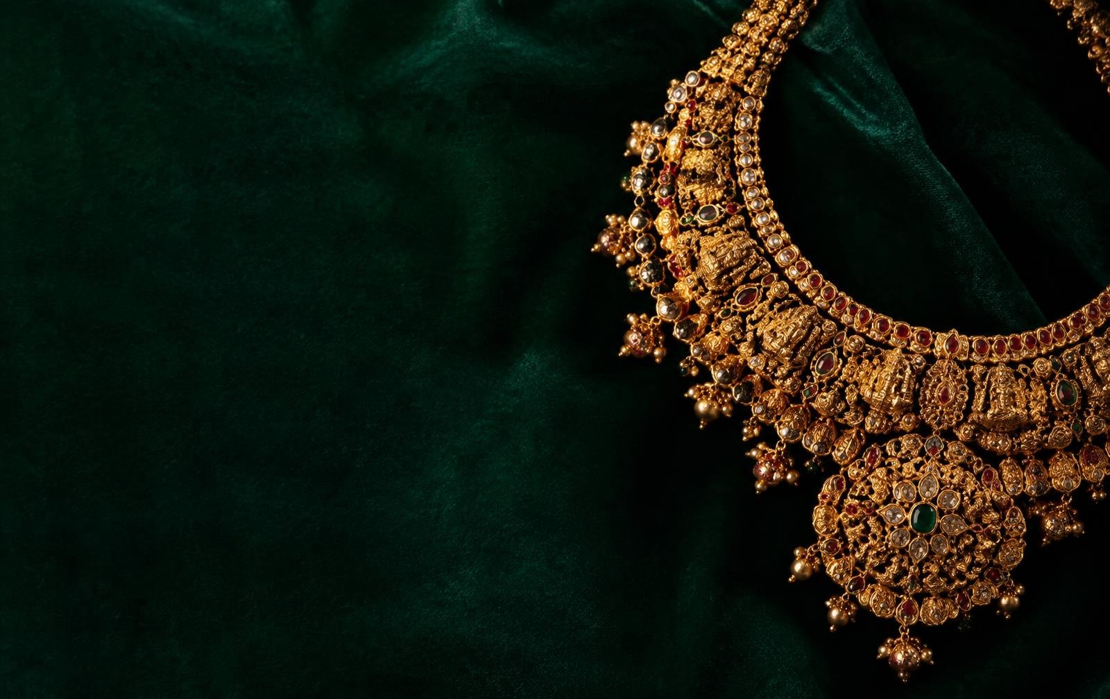 Ornate bridal gold necklace on emerald velvet