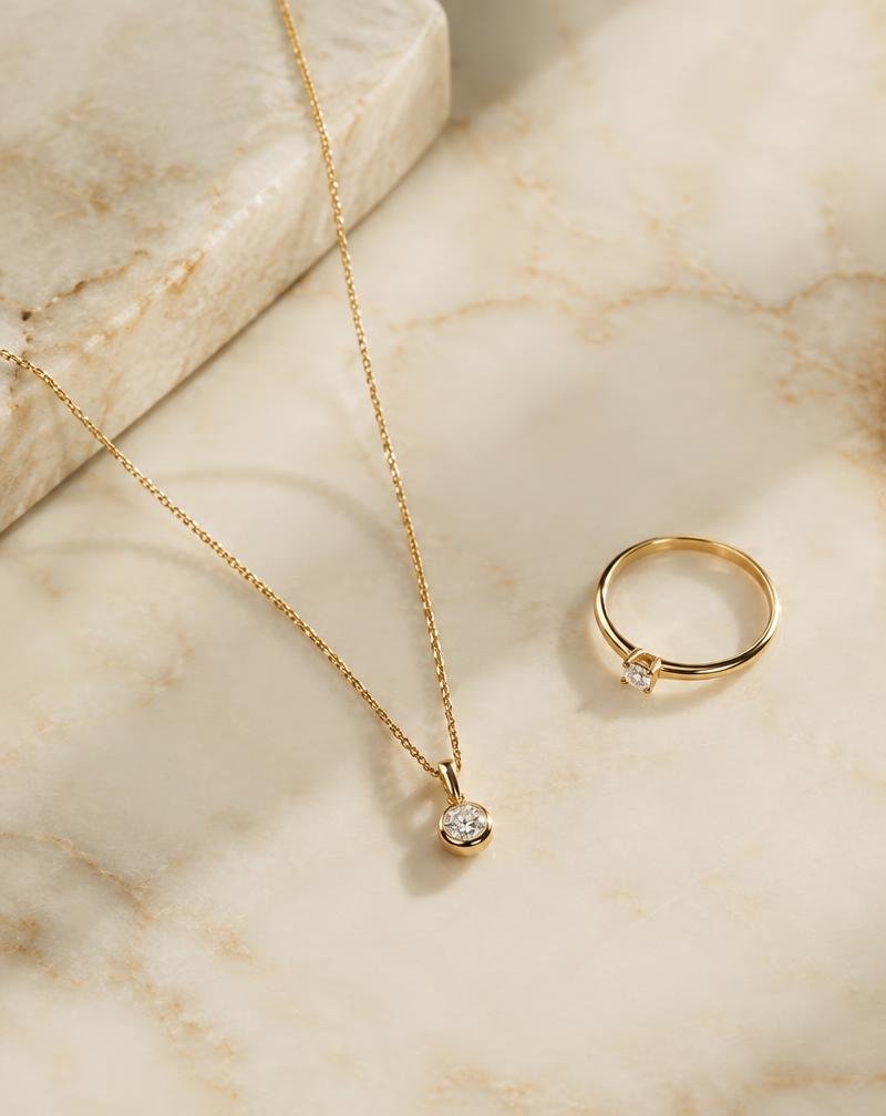 Fine gold chain with pendant on marble